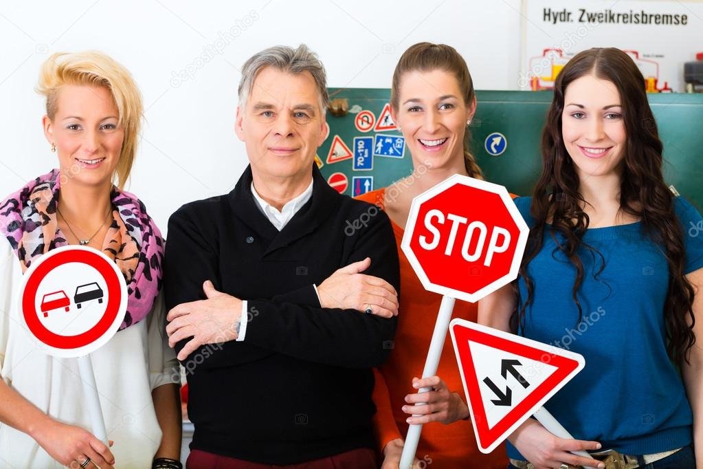 Driving instructor sitting beside a learner driver in a dual-control car